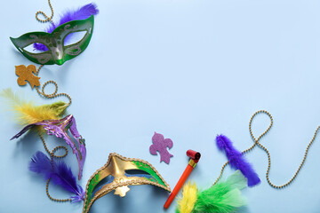 Carnival masks with party horn and decor for Mardi Gras celebration on blue background