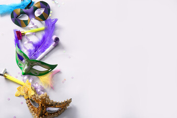 Carnival masks with party horns and decor for Mardi Gras celebration on white background