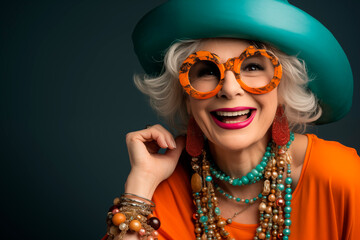 cheerful elderly woman in bright clothes having fun, rejoicing and dancing. Fashion portrait. Summer style.