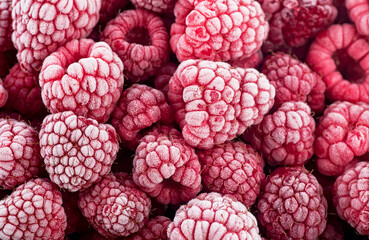 Tasty frozen raspberries as background, top view. Ripe raspberries with frosty freshness. Fresh summer berries.