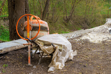 Concrete mixer at a construction site. Background with selective focus and copy space