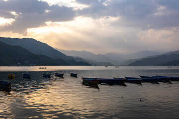 sunset with boats over the lake