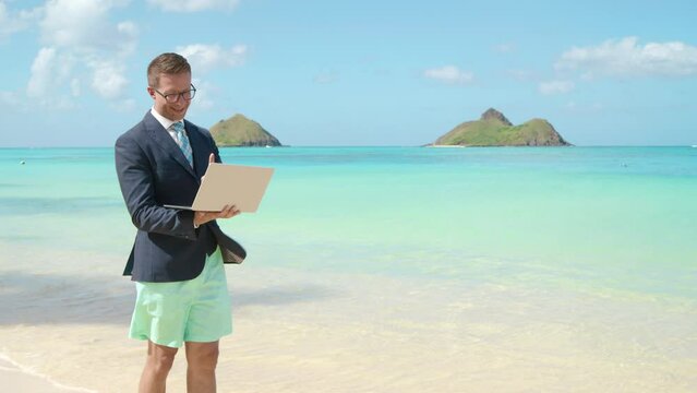 A young professional male stands on a sunny, white sand beach, half-dressed in business attire and swim shorts, focused on his laptop, Calm sea create a serene backdrop for this unusual office setup 