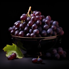 Blue grapes in a plate. Dark grapes in porcelain plate on a black background. Bunch of grapes with leaves. Summer berries. Sweet delicious grapes.