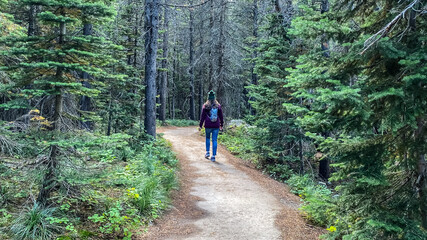 Woman Hiking around Swiftcurrent Lake in Many Glacier Region of Glacier National Park