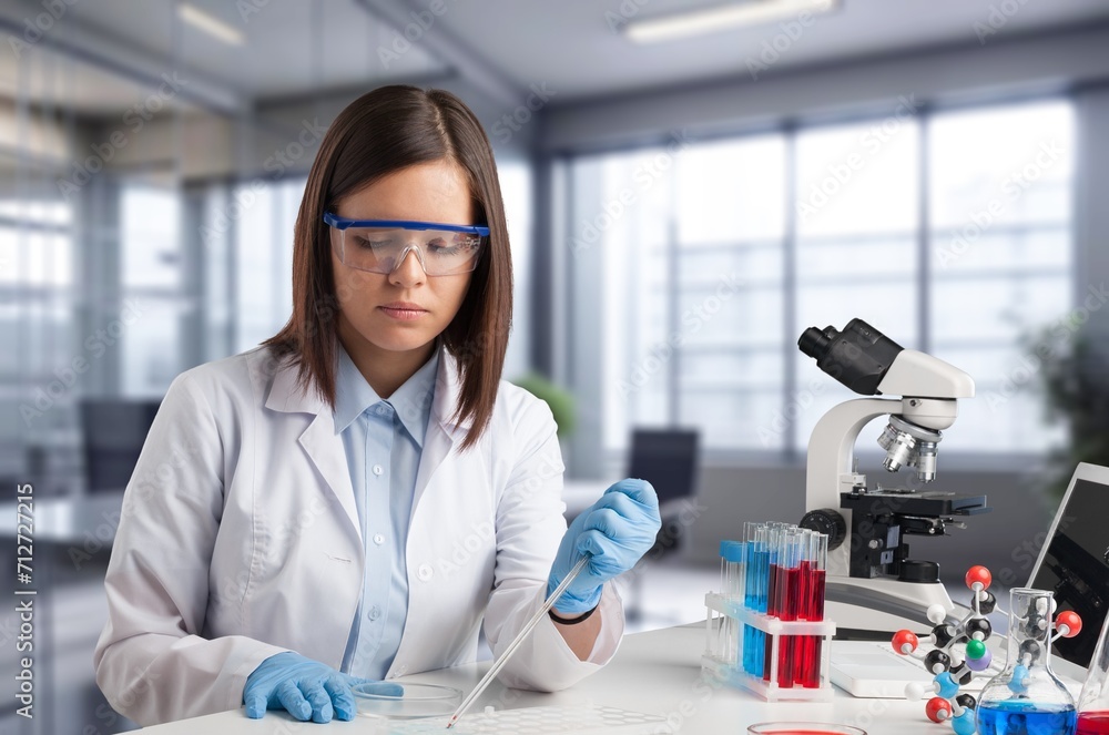 Poster technician worker testing sample in the lab.