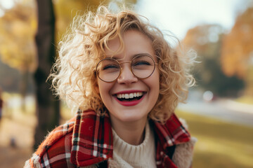 Joyful Woman with Curly Hair Laughing Outdoors
