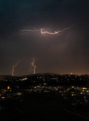 Naklejka na ściany i meble Lightning Strikes at night during a storm over houses in the northern beaches of Sydney, Australia