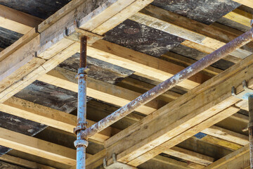 Fototapeta na wymiar An outdoor construction site. Construction of a new building. Block construction, reinforced concrete beams and wooden floors and roofs.