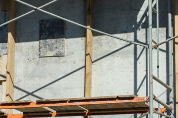 An outdoor construction site. Construction of a new building. Block construction, reinforced concrete beams and wooden floors and roofs.