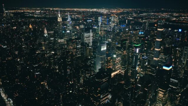 Aerial Time Square downtown panorama. Drone flight above high skyscrapers building after dark.Scenic night time areal above modern night city. Illuminated Manhattan USA. New York City views background