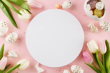 Crafting a festive Easter setting. Top view shot of egg-shaped saucer, painted eggs, tulips,...