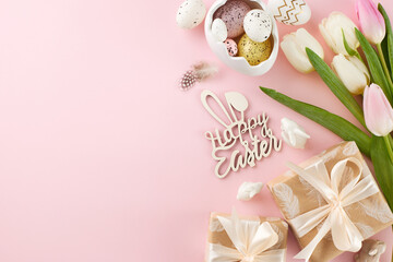 Fototapeta na wymiar Festive Easter gathering: renewal and rejoicing. Top view photo of egg-shaped saucer, festive gift boxes, eggs, feathers, flowers on pastel pink background with promo area