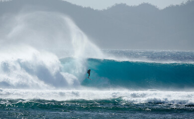 Surfer on a wave in Fiji 