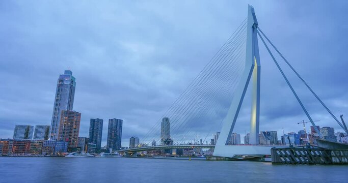 Rotterdam, Netherlands - December 26, 2023: Rotterdam nighttime panorama with “Erasmus-Bridge“ over river Nieuwe. Time-lapse video.