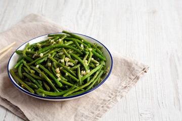 Homemade Asian Garlic Green Beans on a Plate, side view. Copy space.
