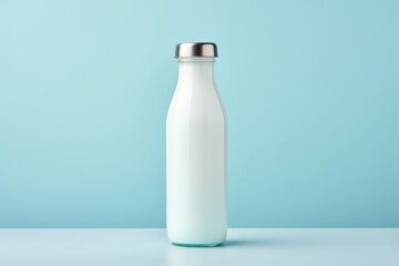 For industrial design. model of milk bottle made of glass with silver cap. on light blue background. - obrazy, fototapety, plakaty