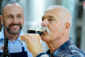 senior brewer tasting beer in the glass