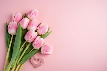 A bouquet of pink tulips on pink background with space for text. Greeting card for valentine's day or mother's day