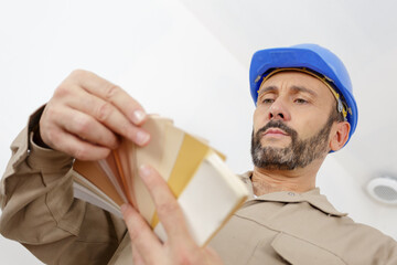 a painter holding color swatches