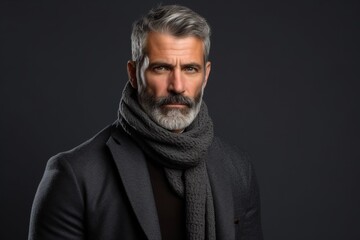 Portrait of a handsome mature man wearing a coat and scarf.