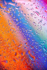 colorful light and water drops on glass, breathtaking view created by light and water. Macro...