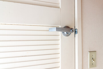 metal door handle on a white wooden door.Door handles elements close up.