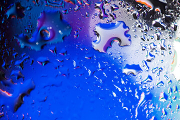 colorful light and water drops on glass, breathtaking view created by light and water. Macro...