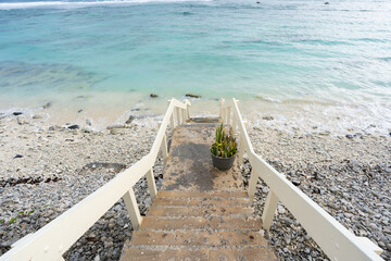 A stairway leading to a beach on a tropical Pacific island