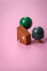 A small wooden house and keys as an idea for investing in your own home and achieving the goal of buying real estate