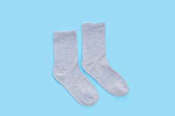 Grey socks on blue background.