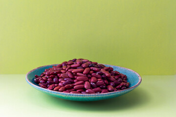 Red kidney beans in a rustic bowl with outstanding details as  background 