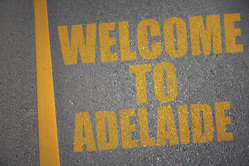 asphalt road with text welcome to adelaide near yellow line.