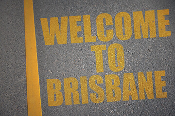 asphalt road with text welcome to brisbane near yellow line.