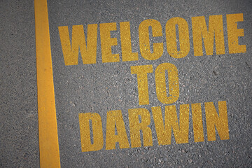 asphalt road with text welcome to Darwin near yellow line.
