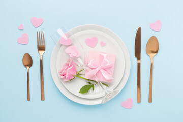 Festive table setting for Valentine's Day on color background, top view