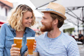 couple laughing and having fun while drinking beer