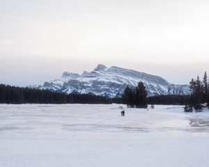 frozen mountain lake with snow covered mountains