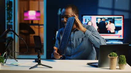 African american technology internet star filming review of newly released keyboard and mouse set, greeting audience and presenting them feedback about sensor sensitivity, doing endorsement
