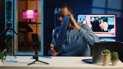 African american technology internet star filming review of newly released keyboard and mouse set,...