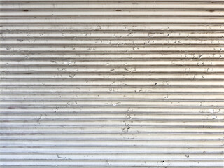 Metal rolling door with peeling white paint - 712773475