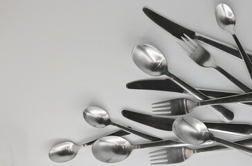 Cutlery - forks, knives and spoons on a white background
