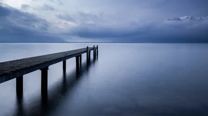 Zelfklevend Fotobehang Pier on a calm swiss lake © Jerophoto