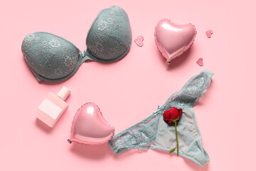 Frame made of sexy lingerie, heart-shaped balloons and perfume on pink background. Valentine's Day...