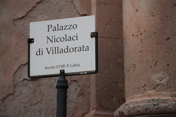 noto sicily italy palazzo nicolaci di villadorata white black sign writing caption text evening...