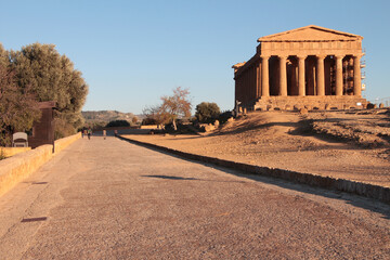 agrigento sicily italy ancient temple of concordia pillars wide shot next to ancient street road