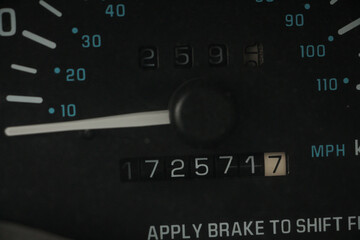 speedometer gauge needle handle dashboard numbers mileage mph kmph white black, close up on mileage