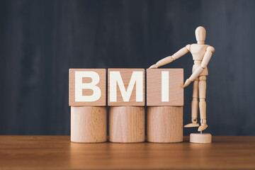 There is wood cube with the word BMI. It is an abbreviation for Brain Machine Interface as...
