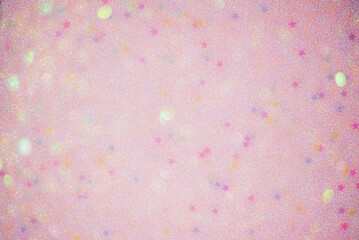 Pink defocus background with glitter stars and defocus lights. Pink glitter paper in defocus.