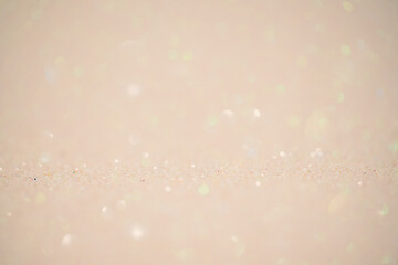 Beige glitter background. Mixed background, the main part is defocused and the thin focal part.